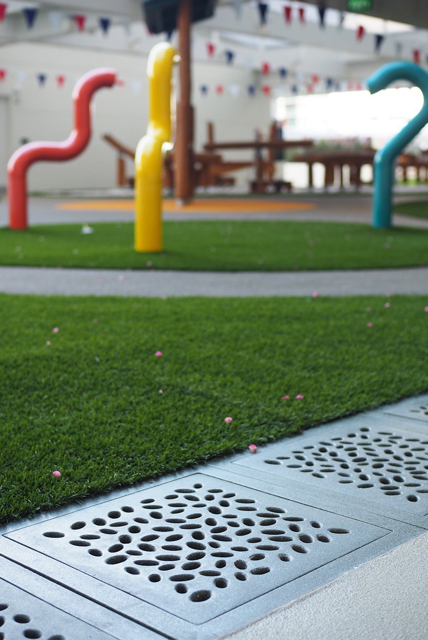 Outdoor children's play area Jonite custom trench grates