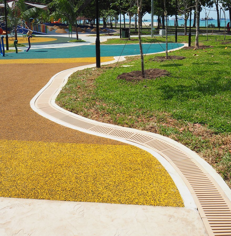 Jonite channel grates colour matched to play area Marine Cove Singapore
