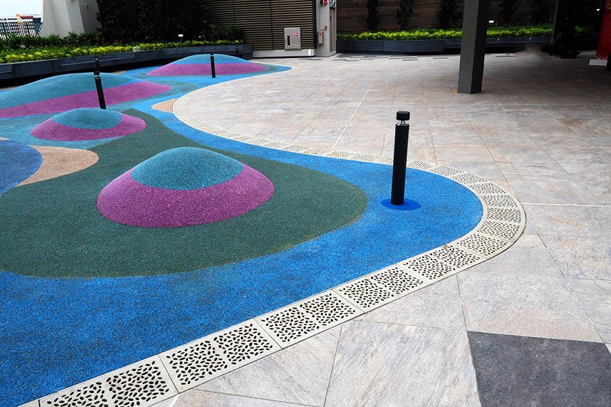 colorful children's playground with Jonite trench grates