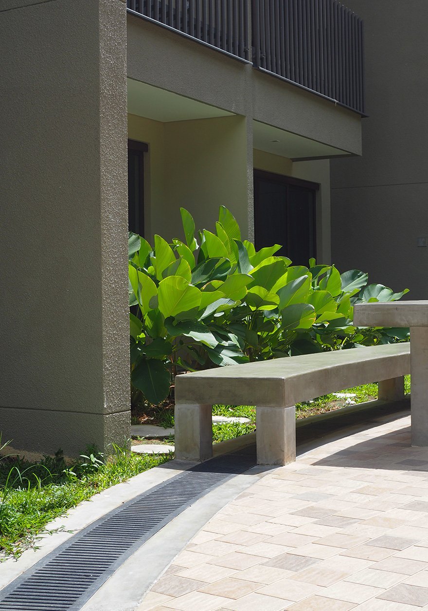 Jonite stone grates installed under a bench outside of Downtown East