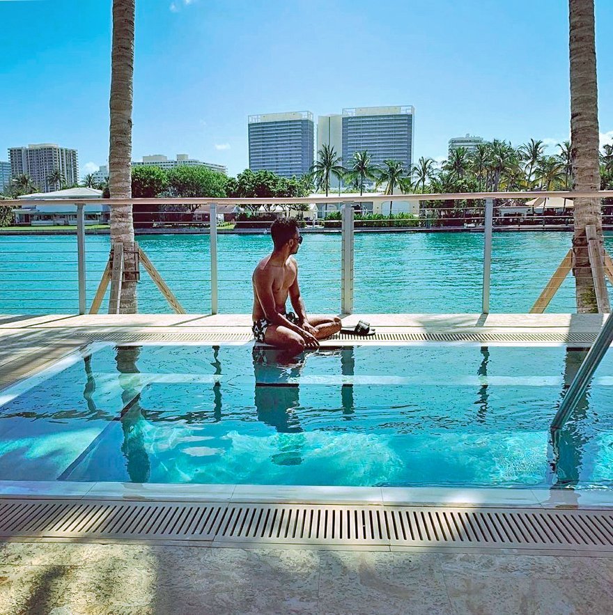 Man sitting on the Jonite pool grates at the edge of a small pool at the Grand Beach Hotel