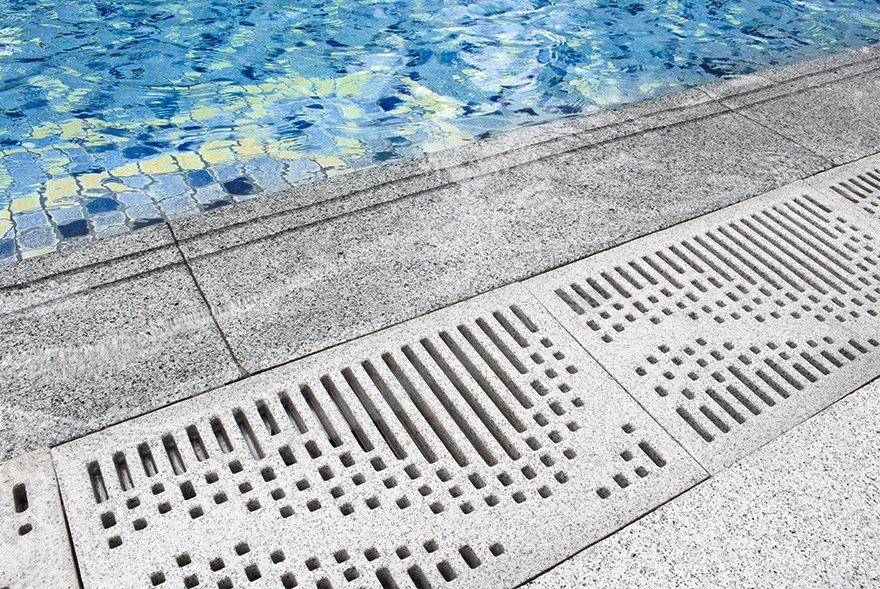 close up of Jonite stone pool grates next to the water at 57 Grange Road