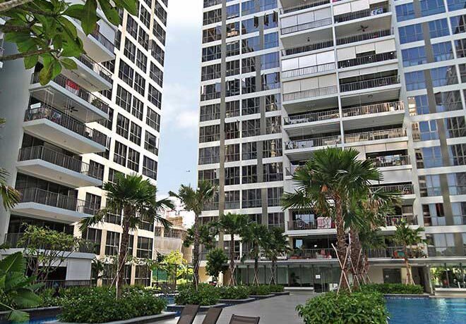 outdoor view of pool, palm trees, and greenery at Punggol Waterwoods