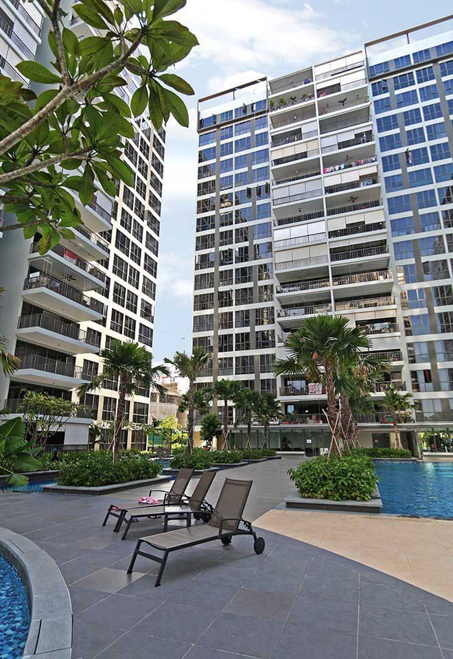 outdoor view of pool, palm trees, and greenery at Punggol Waterwoods