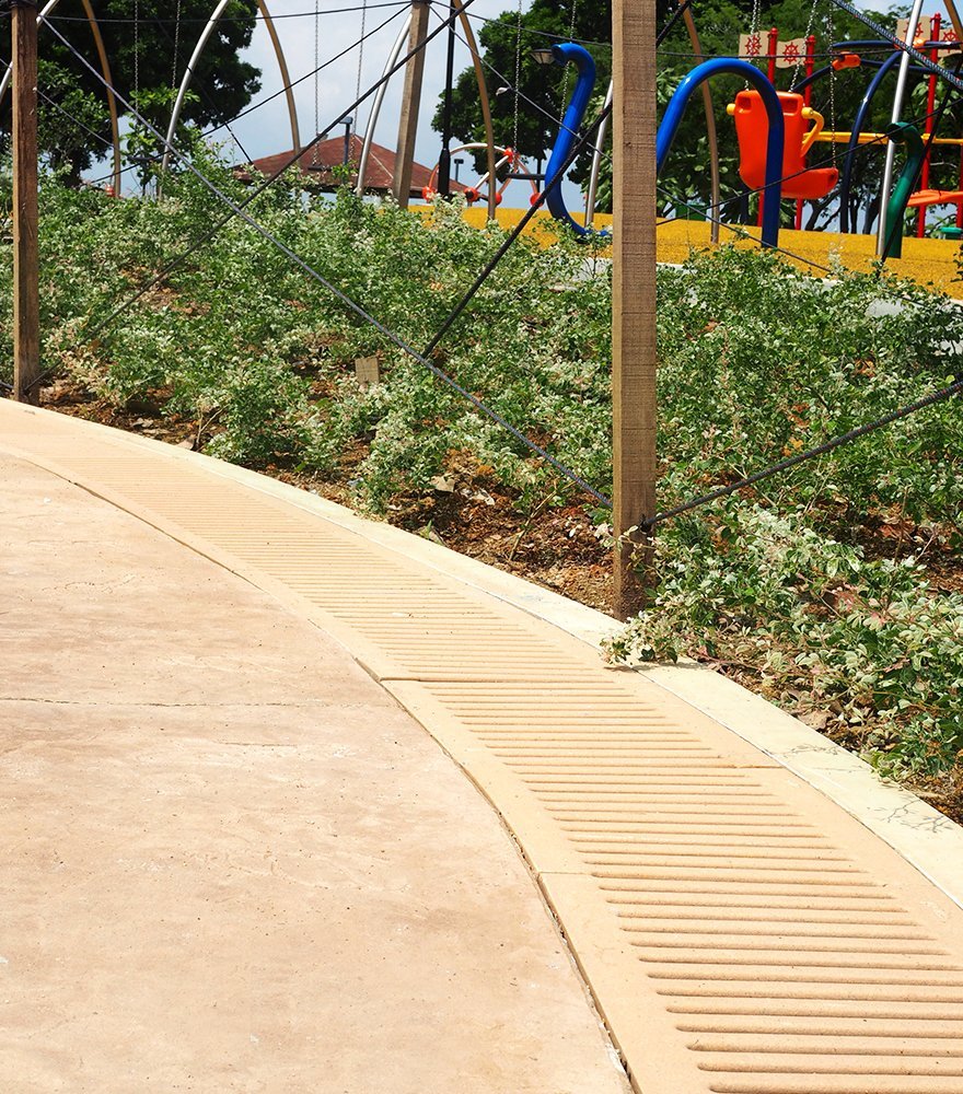 Jonite trench grates colour matched to pavement in Marine Cove