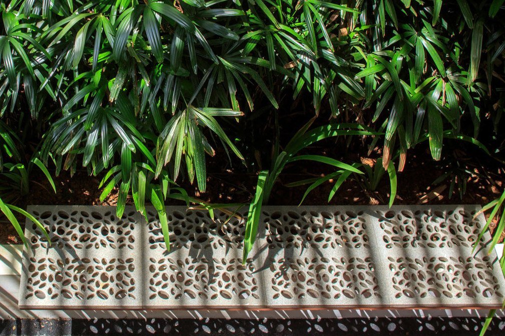 view of Jonite stone bench next to greenery