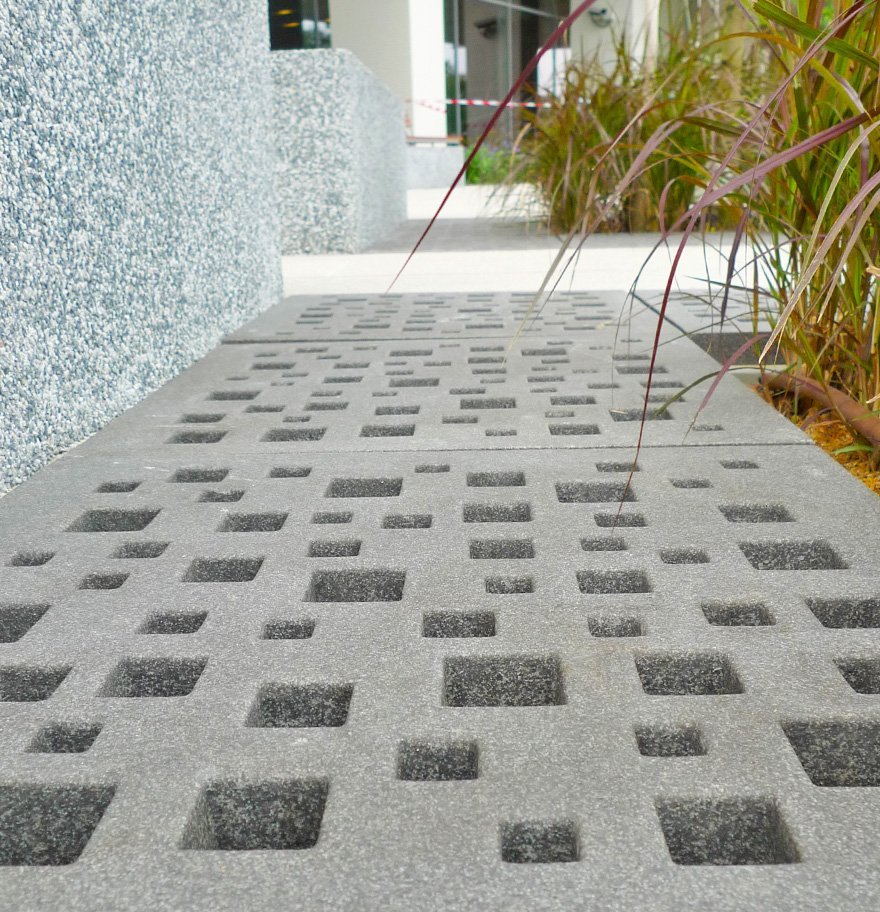 close up image of Jonite stone grates next to plants at NUHS