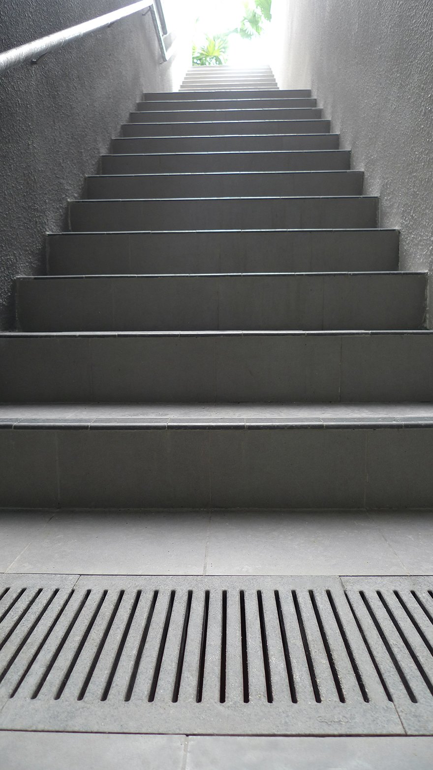 Reinforced stone grates matching tiles in stairwell