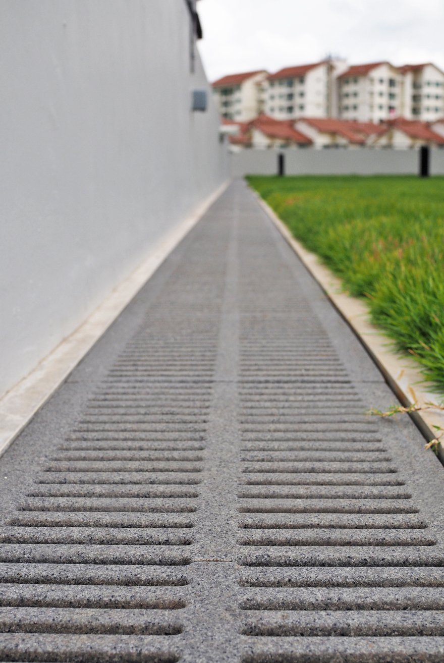 Jonite reinforced reconstituted stone trench grates line the SUTD campus