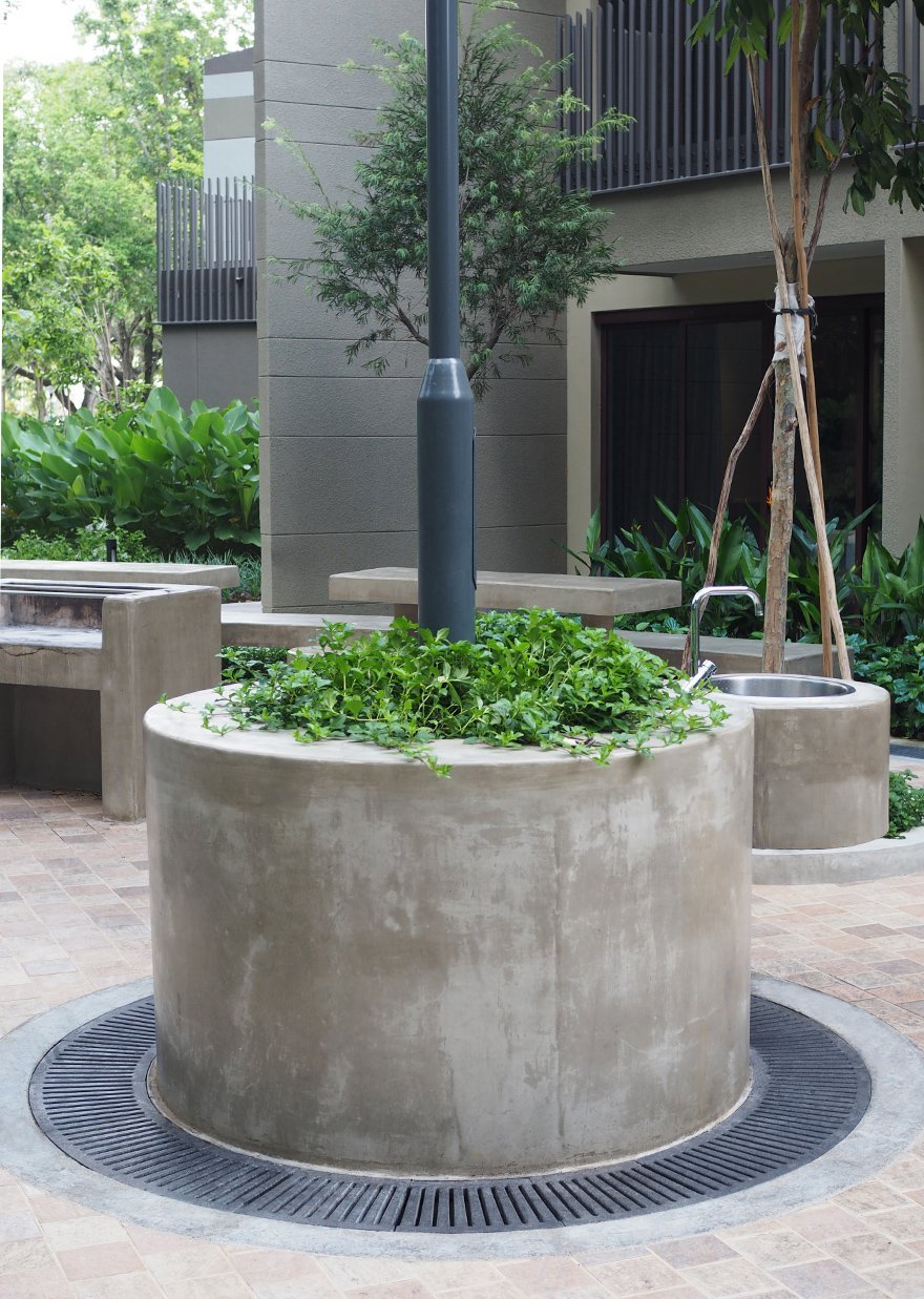 Jonite grates around a cement pillar and light post at Downtown East