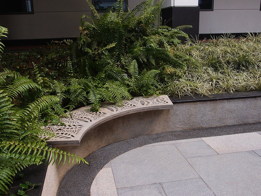 Jonite Stone bench next to ferns at Yale NUS