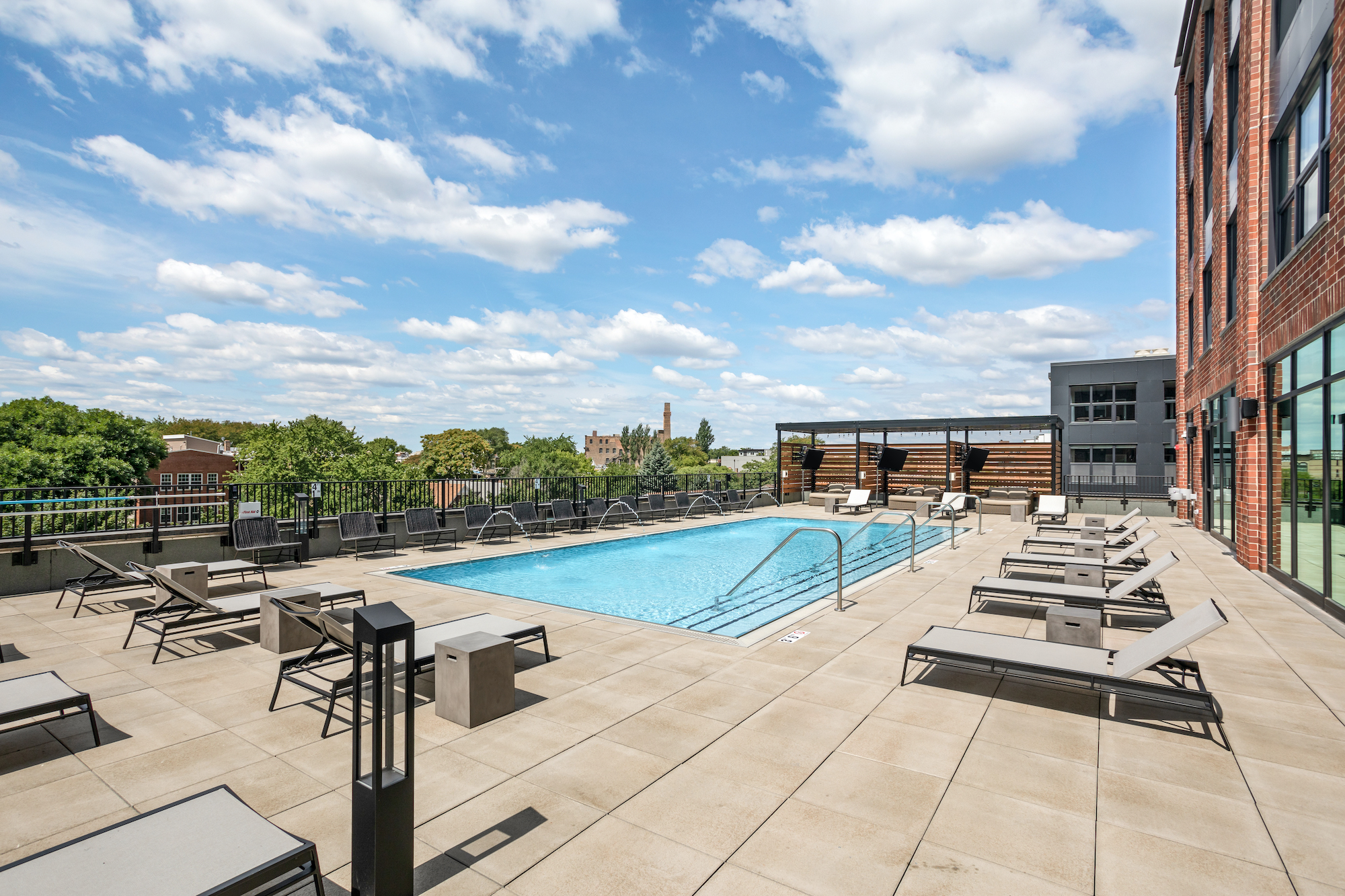 pool chairs and benches around the pool at Logan Square Apartments