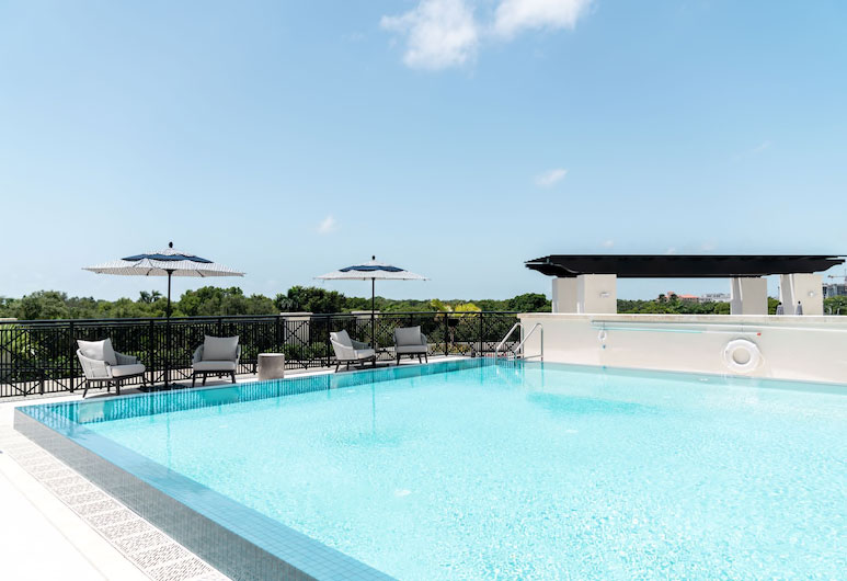 pool with seating areas at Paseo de la Riviera