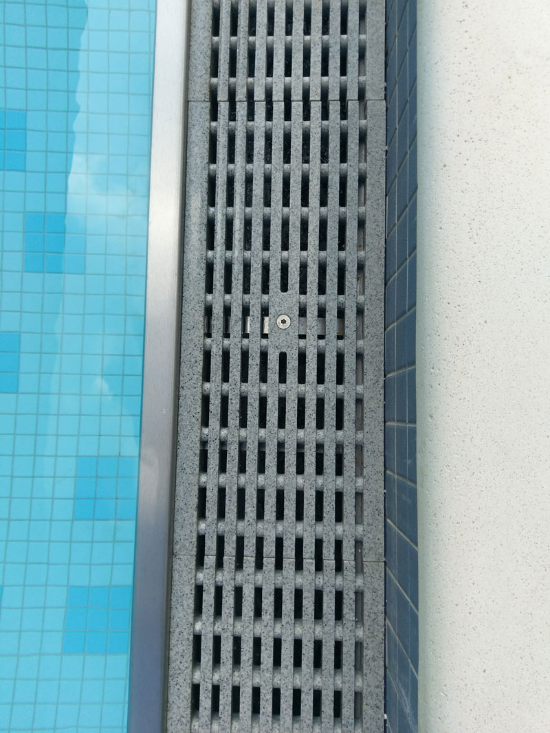 close up view of the stone grate at the edge of the pool at Sky View Parc