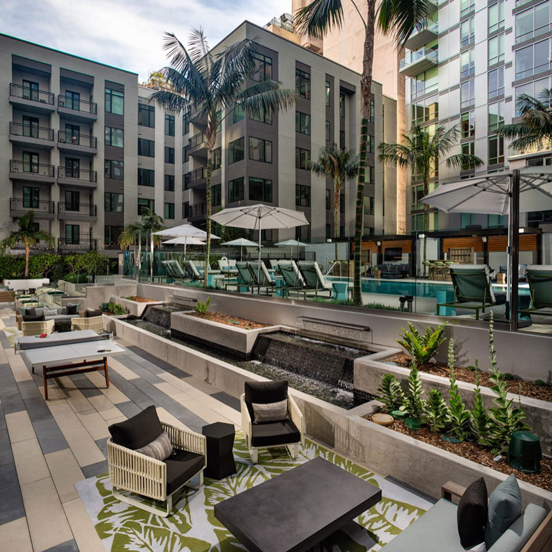 outdoor seating area below the swimming pool at Trademark 437