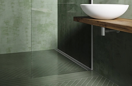 Modulo TAF drain installed in a green bathroom