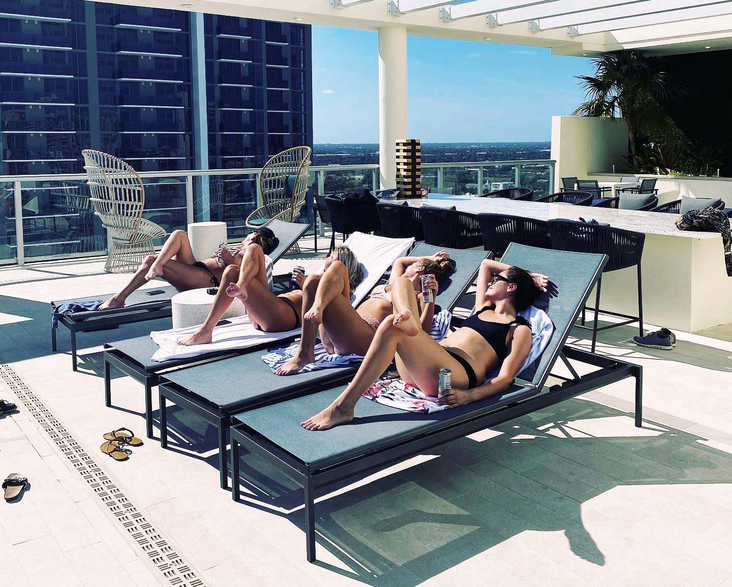 women sunbathing by the pool at 4 West Las Olas