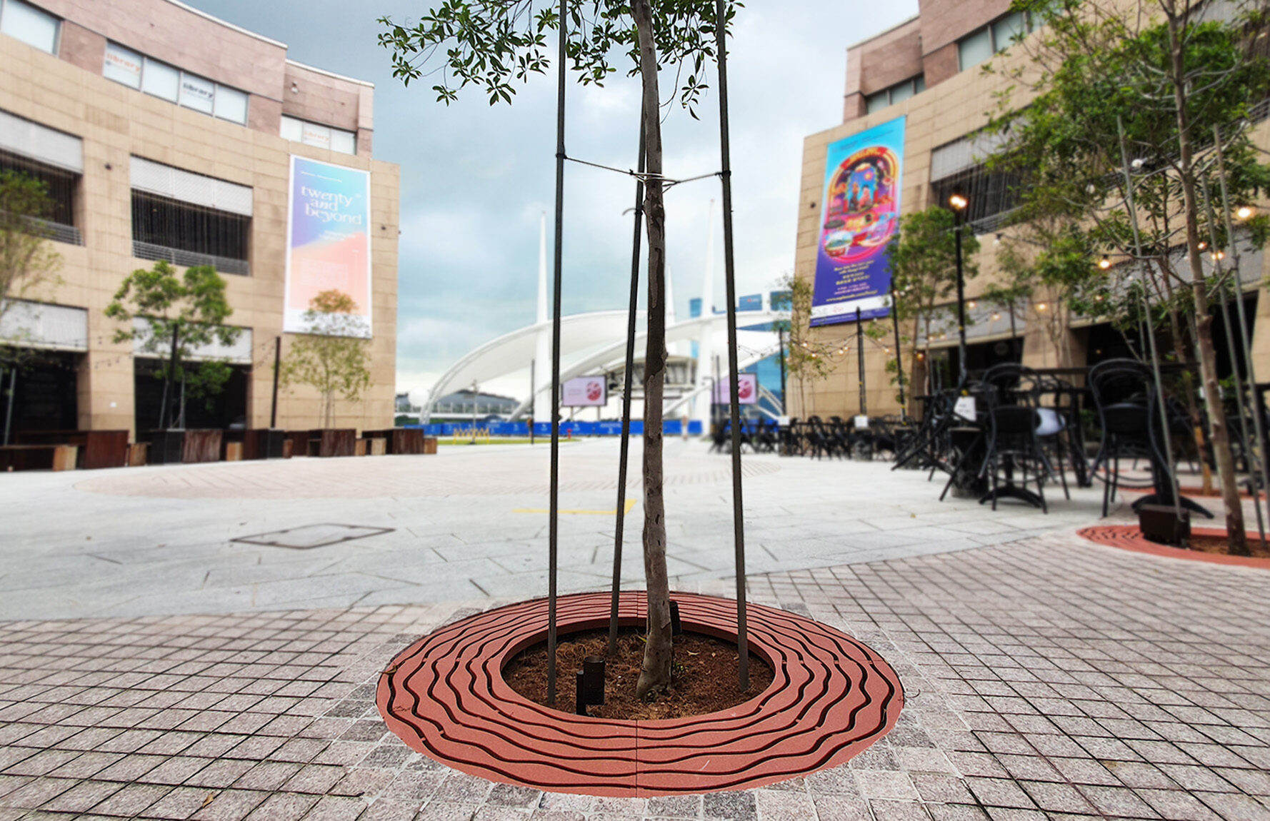 red Jonite stone grate around a tree at Esplanade