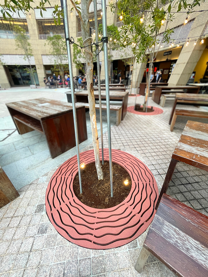 custom Jonite tree grate surrounding a tree at the Esplanade